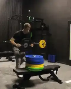 man flips over bench with weights