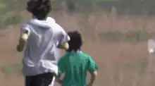 Two boys running, one catches fire