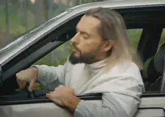 Man sleeping in car wakes up to see man by tree