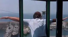 Man jumps out of window with arms wide