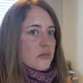 Woman with freckles looking at camera