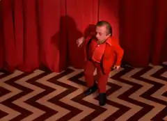 Dancing man in red suit zigzag room