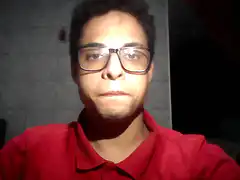 Man in red shirt and glasses blinking
