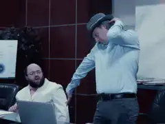 Man in hat slams laptop on desk
