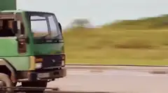 Green truck drifting on test track