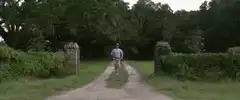 Man in red hat running down country road