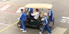 Golf cart pushes man into parking lot