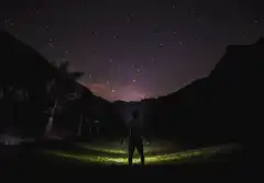 Man standing under starry night sky