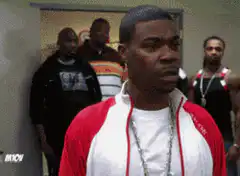 Tracy Morgan smirking and walking through a doorway