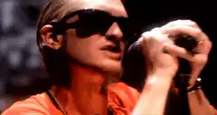 Bono singing passionately into a microphone