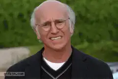 Larry David grimacing and looking around