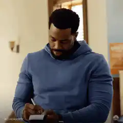 Chicago PD man writing then looks up