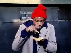Man eating toast with knife