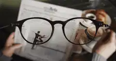 Glasses magnifying newspaper photo