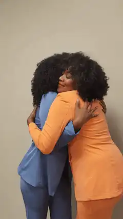Two women hugging and smiling