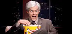 Bill Hader eating popcorn with wide eyes