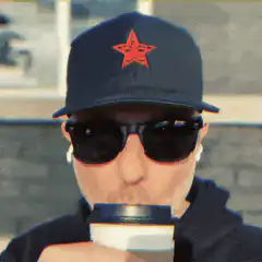 Man in star hat sipping coffee