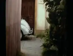 Man in green suit runs past car