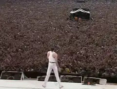 Freddie Mercury raises arm to crowd