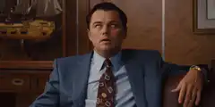 Leonardo DiCaprio coughing in a suit