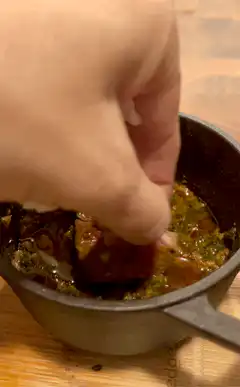 Hand dipping food in sauce