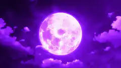 Glowing purple moon in clouds