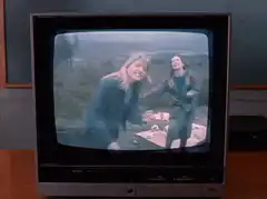 Blonde woman on TV zooms into eye