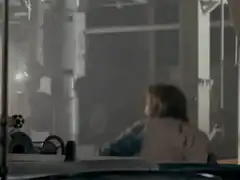 Man firing two guns in a factory