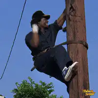 Man climbing pole with boxing gloves