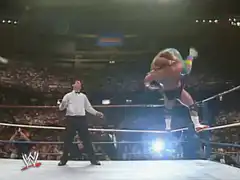 Wrestler jumping over two down opponents