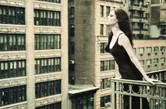 Woman in black dress on balcony