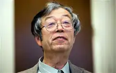 Man with glasses looking up