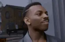 Daniel Kaluuya pointing at head
