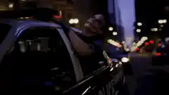 Joker leaning out of police car window