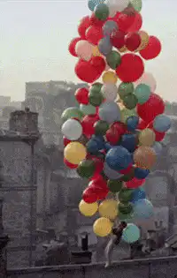 Man lifted by colorful balloons