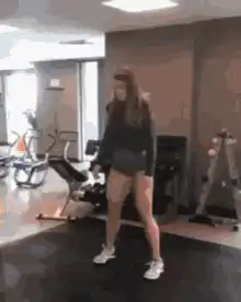 woman does splits in gym