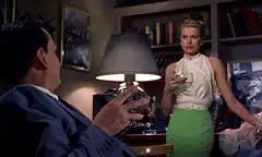 Grace Kelly holding a drink in a room