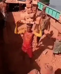 Man balancing bricks on head