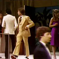man in yellow suit trips and falls
