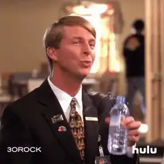 Jack Donaghy spits out water