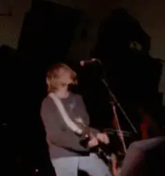 Kurt Cobain playing guitar on stage