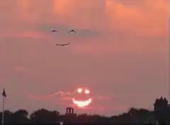 Smiley face in the sunset sky