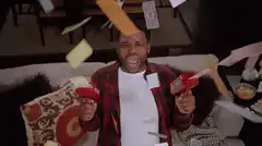 Man shooting money with money guns