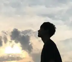 silhouette of man against cloudy sky