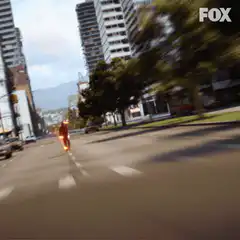 The Flash running down a city street