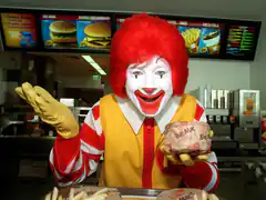 Ronald McDonald shrugging with a Big Mac