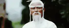 Old man with white beard points