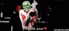 The Mask holding an award saying thank you
