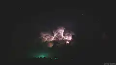Lightning storm over rural landscape at night