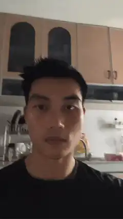 Man flexes muscles in kitchen